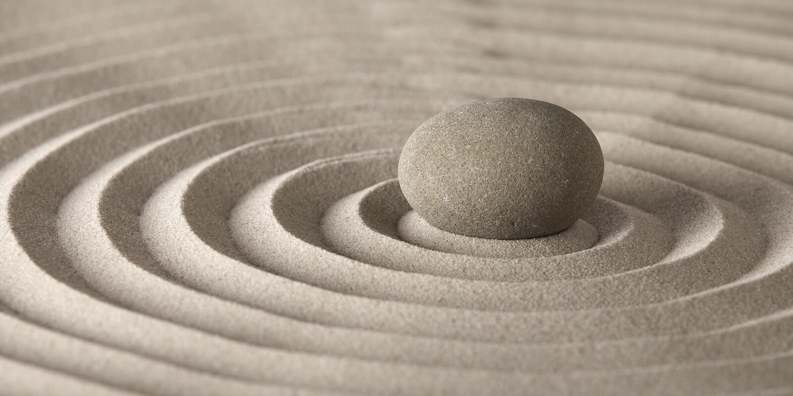 Round rock in the center of a Zen sand-garden.