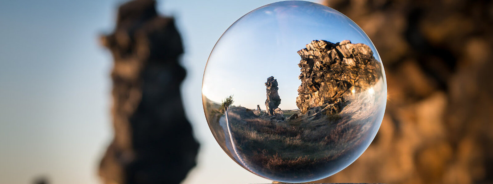 Glass ball reflecting the surrounding cliffs and rocks.