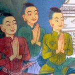 Mural of five smiling Thai men holding their folded hands up in a respectful way.