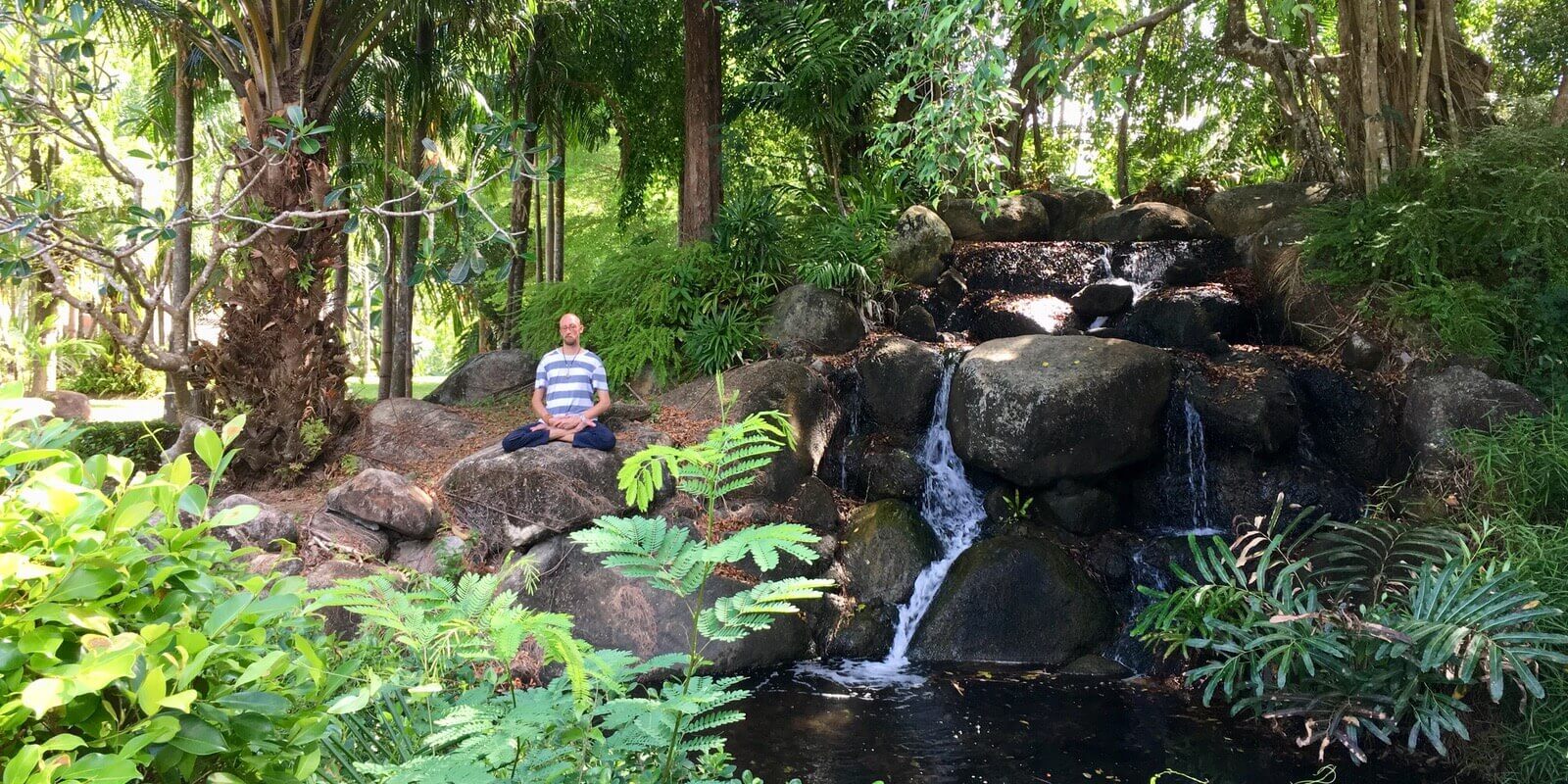 Tobi Warzinek Meditating at a Waterfall in the jungle
