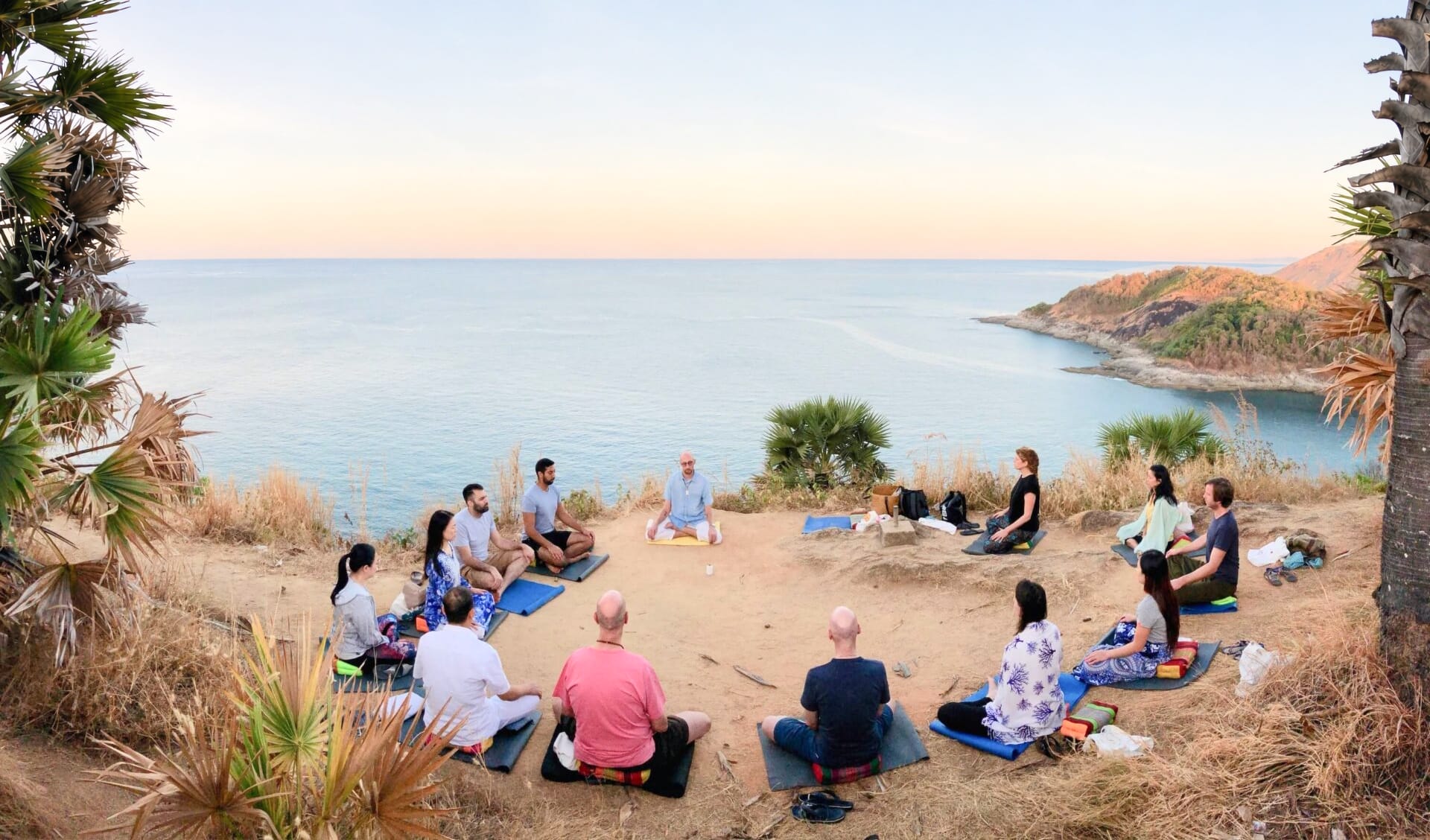 Group meditation session overlooking the ocean during a retreat in Phuket, Thailand